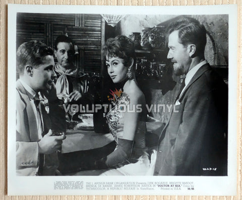 Glamorous Brigitte Bardot surrounded by men in the film Doctor At Sea 