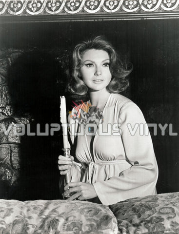 Sylva Koscina in a robe holding a candlestick 